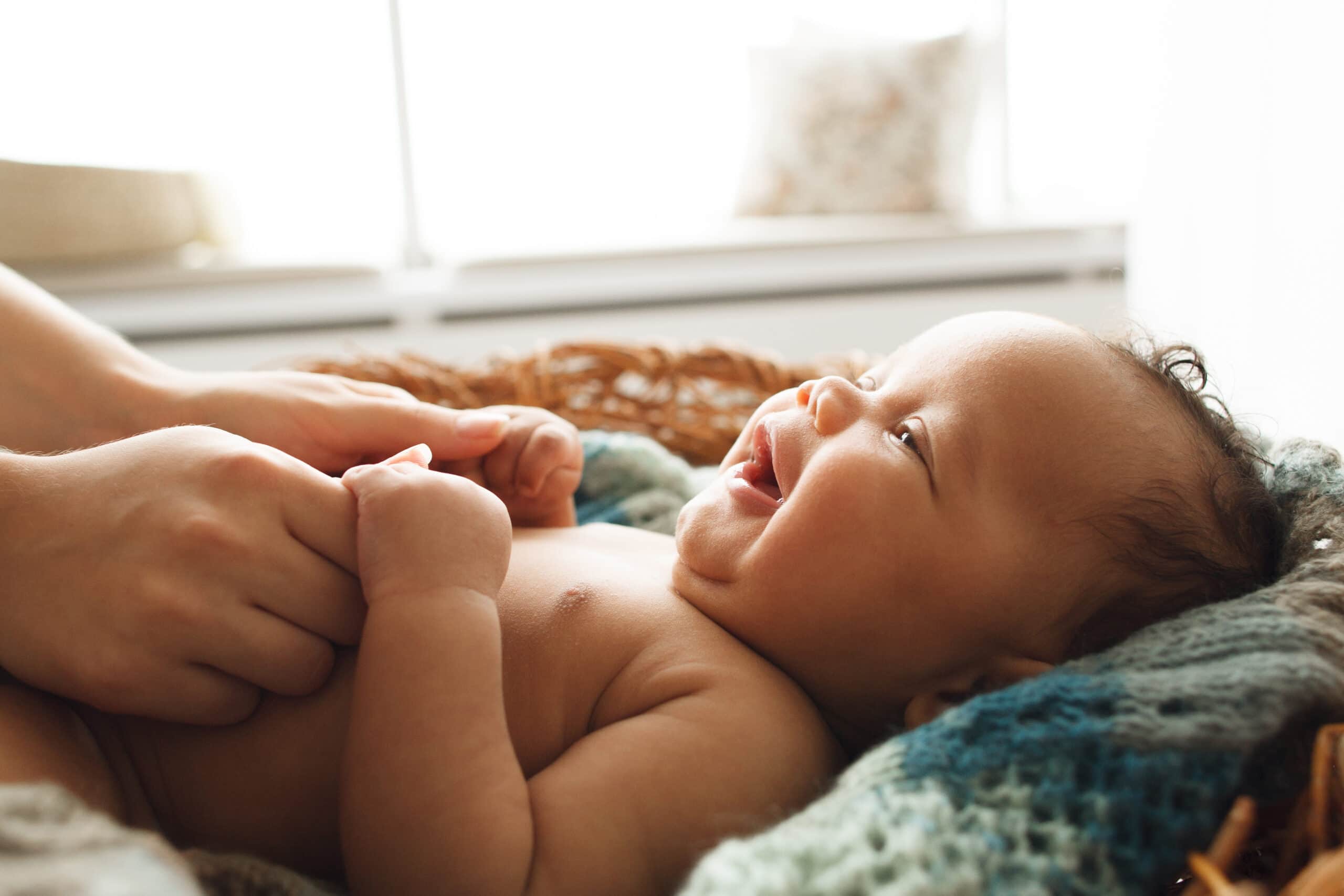 newborn baby smiling at mother